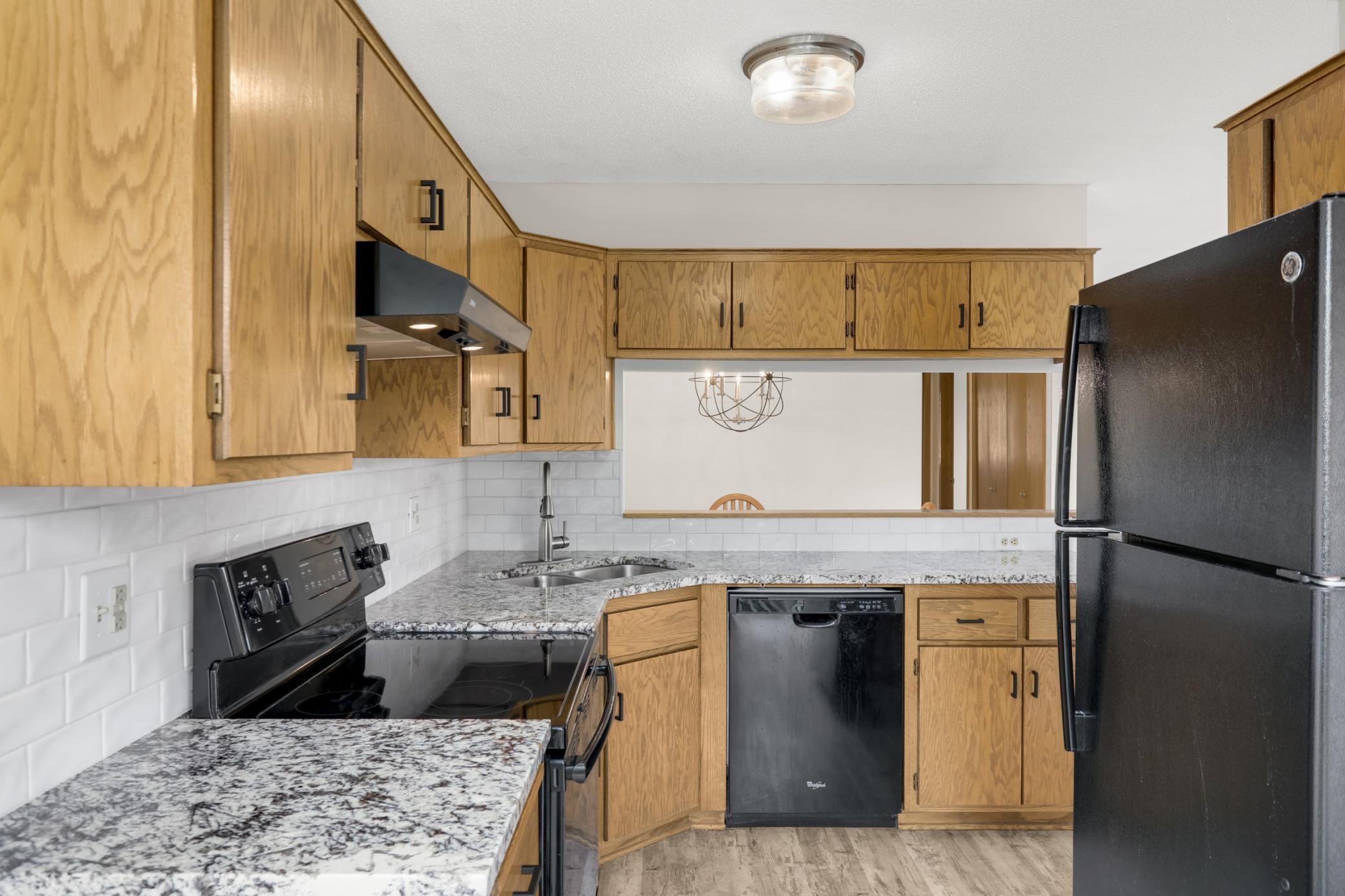 The black appliances give the kitchen a sleek modern appeal. The opening to the dining area is both functional and ties nicely into the open concept area.