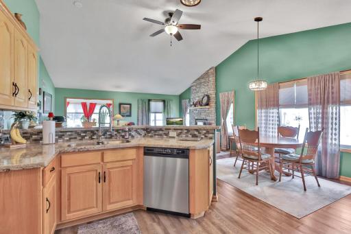 Vaulted Ceilings - Vinyl plank flooring in kitchen and dining area