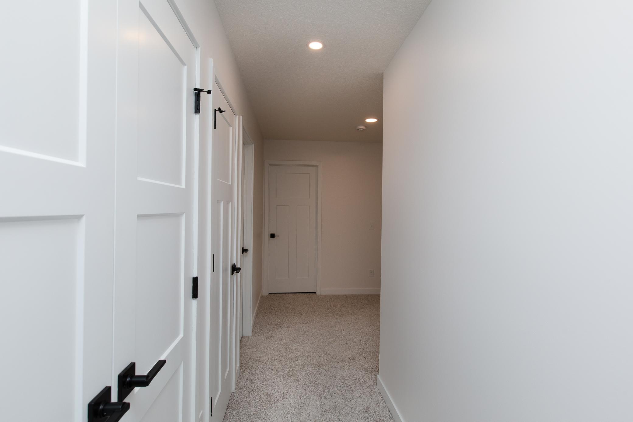 Paneled doors and sleek black hardware provide clean, modern detail