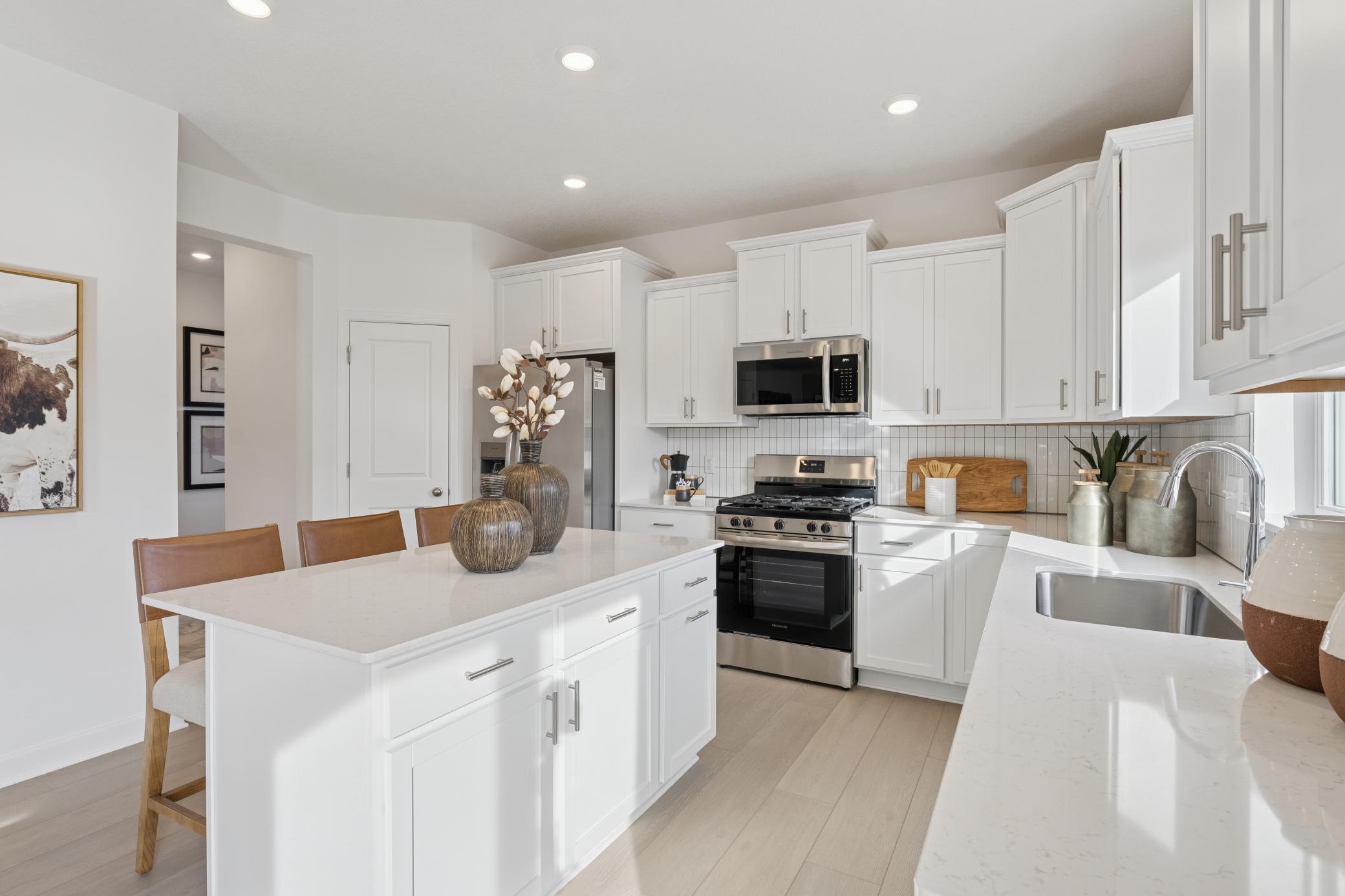 (Photo is of a decorated model, actual homes finishes will vary) Another view of the kitchen.