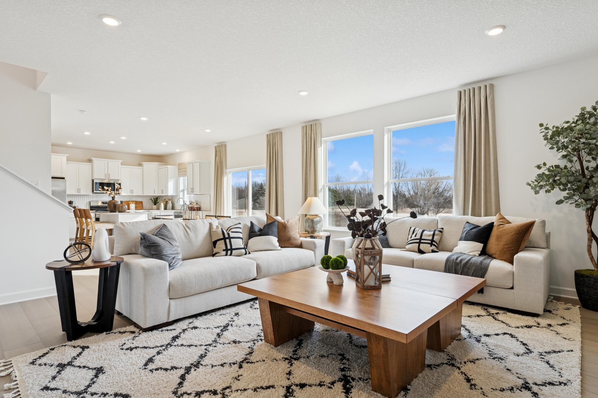 (Photo is of a decorated model, actual homes finishes will vary) An open-concept main level.