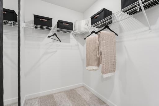(Photo is of a decorated model, actual homes finishes will vary) The primary bedroom includes an incredible walk-in closet.
