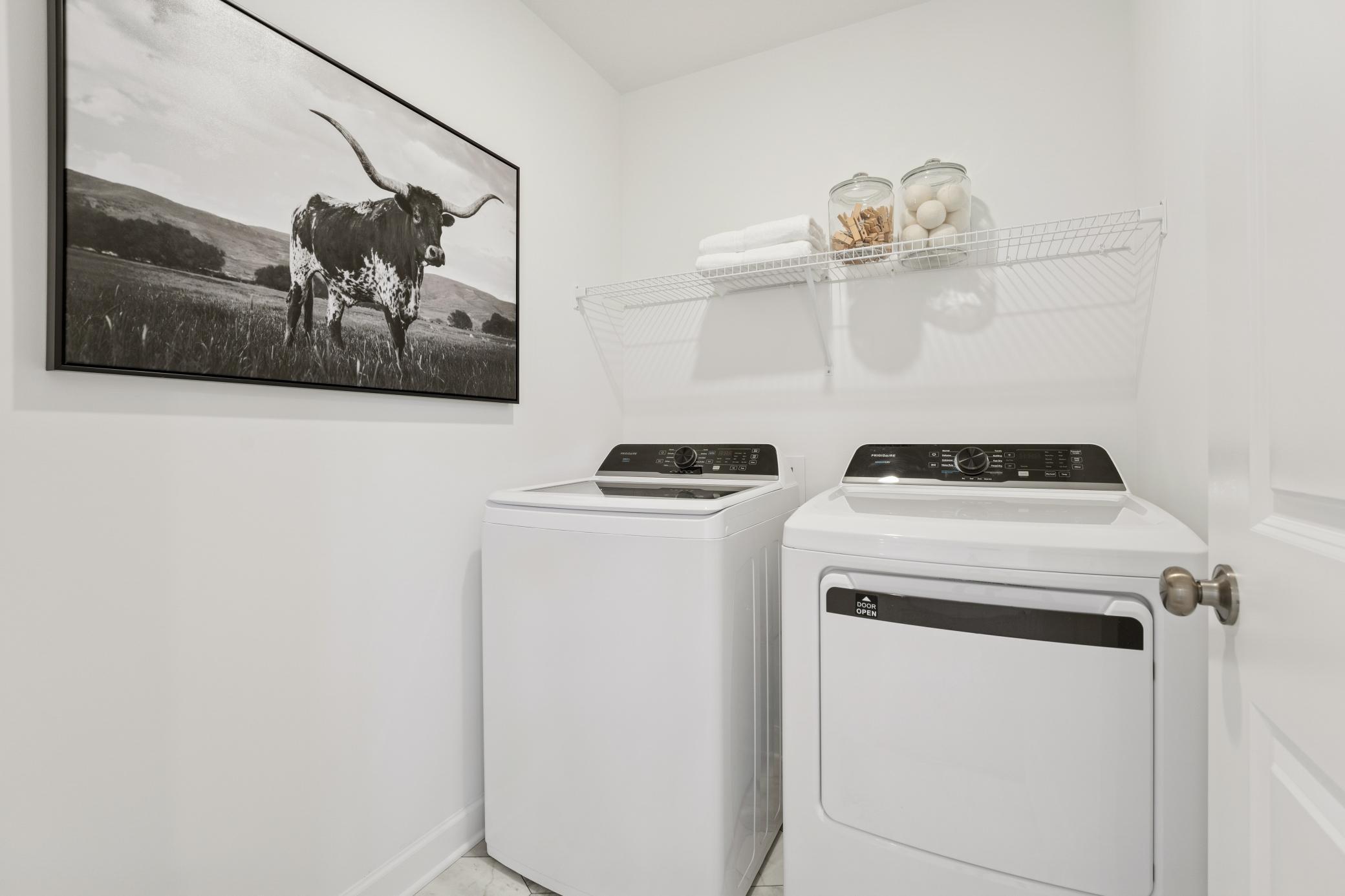 (Photo is of a decorated model, actual homes finishes will vary) Centrally located on the upper level, along with the four bedrooms, this laundry room is sure to provide the ultimate convenience.
