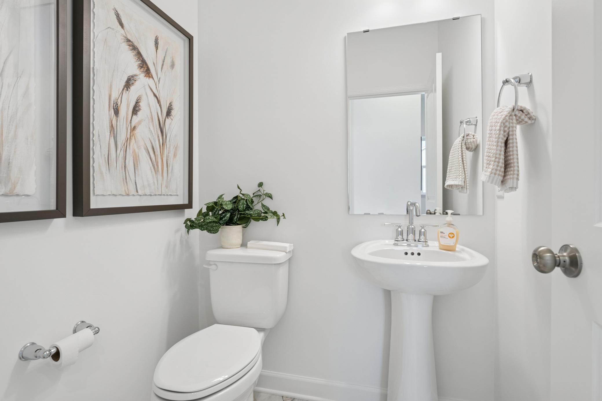 (Photo is of a decorated model, actual homes finishes will vary) Main level powder bath.