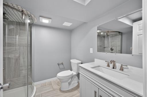 Updated lower-level 3/4 bath with a walk-in shower