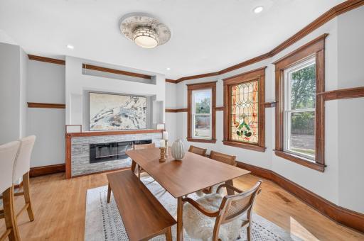 Gather around the fireplace beneath beautiful stained-glass details
