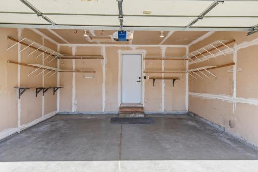2 Car Attached Garage with Lots of Shelving