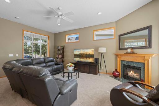 Step inside to an impressive great room featuring soaring ceilings, a cozy fireplace, and windows that fill the home with abundance of natural light.