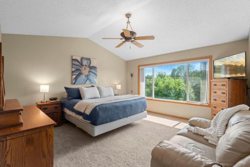 Escape to the spacious primary suite, complete with a vaulted ceiling, large walk-in closet and a luxurious private bath featuring double vanities, a whirlpool tub, and a separate shower.