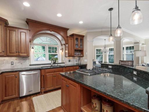 Arched window above the sink overlooking the beautiful side patio.