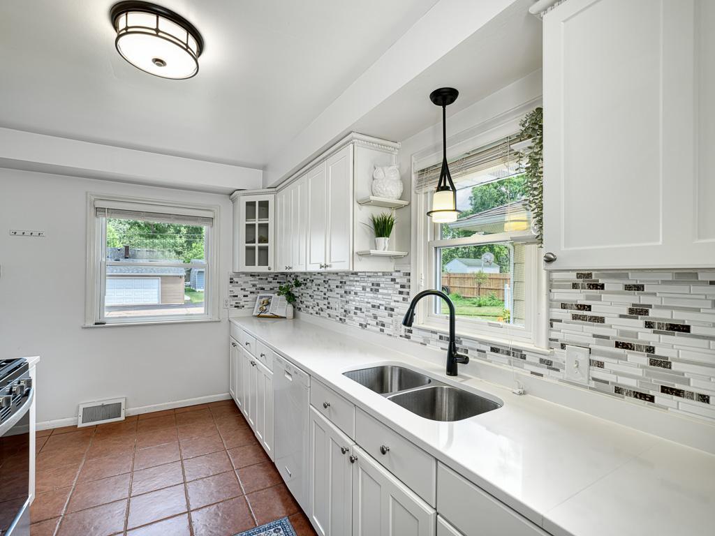 Your updated kitchen features quartz counters and tile backsplash.