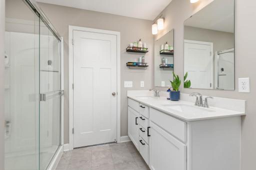 The bath is very well appointed including an oversize shower with corner shelves and a quality glass sliding door.