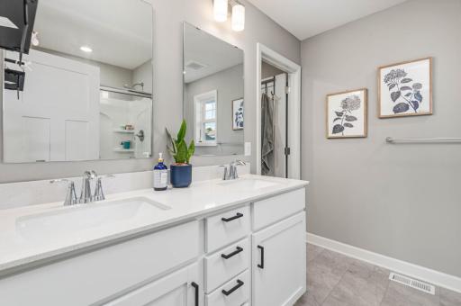The primary suite includes a private bath with double vanity, large shower and spacious walk in closet.
