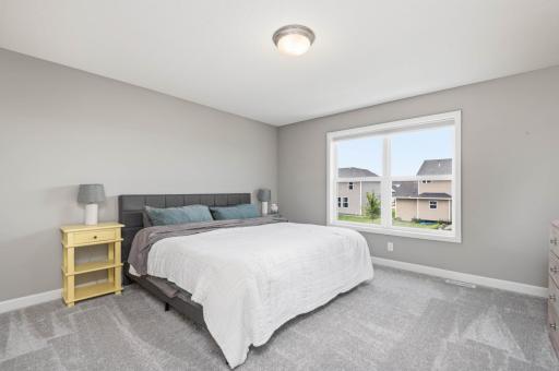 The spacious primary bedroom. Upstairs you will discover four bedrooms and two baths. All four bedrooms have custom room darkening blinds.