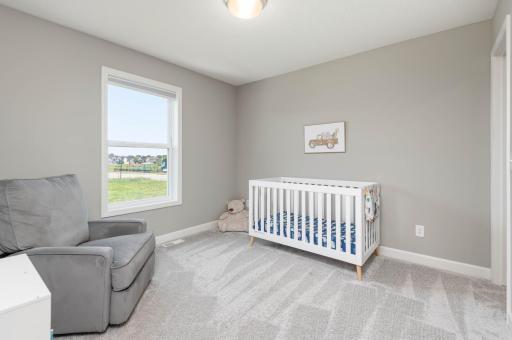 Bedroom 3 overlooks the back yard with a park off in the distance and offers a walk in closet.