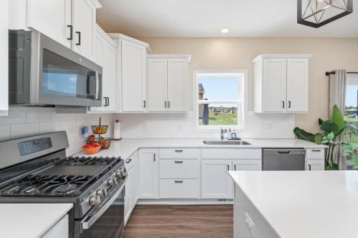 The chef in your family will appreciate all the excellent quartz counter space for meal prep and the five burner gas stove with center griddle!