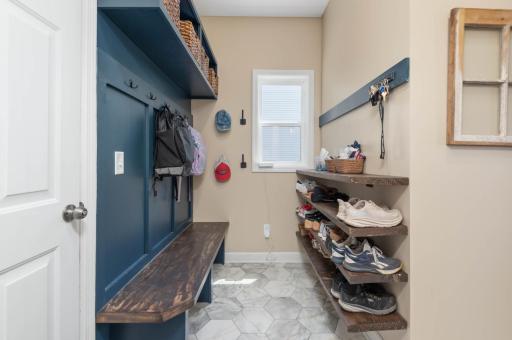 You will appreciate the mudroom with storage closet. The sellers also recently added this bench, coat hooks and storage shelves!
