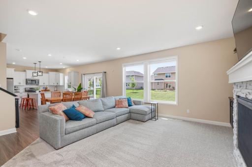 The open floor plan is perfect for family living and entertaining. Great gathering spaces with 9 foot ceilings and recessed lighting.