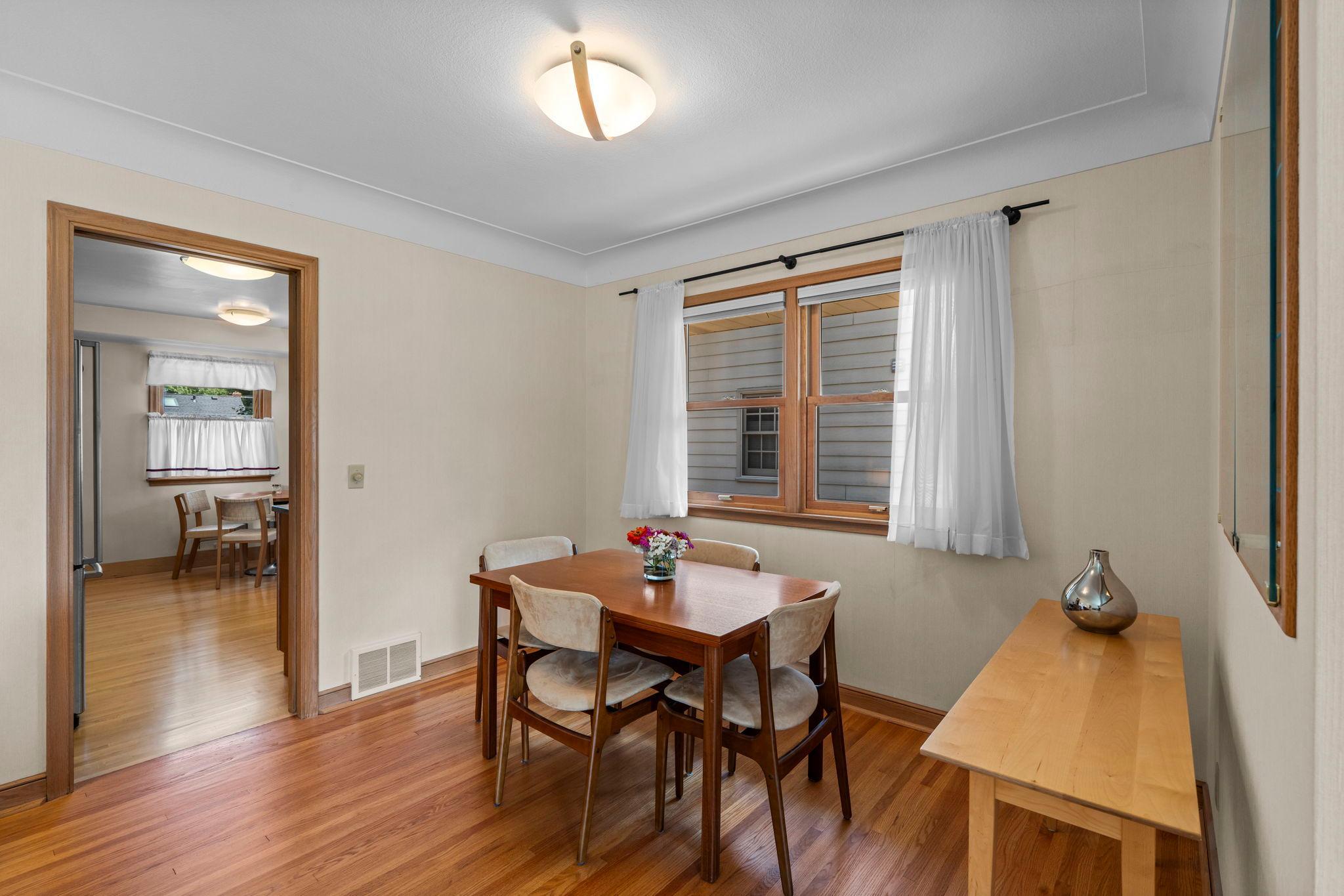 Just beyond, the dining room provides a charming setting for everyday meals or entertaining, complete with built-in glass shelving for added character.