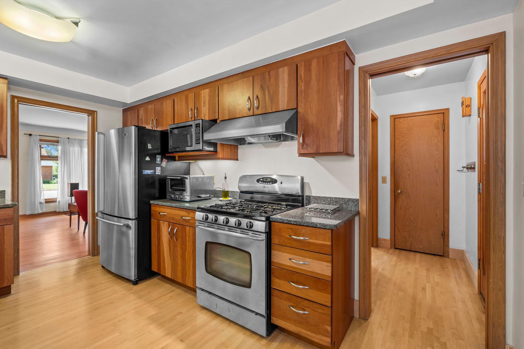 Stainless steel appliances and rich wood cabinetry.