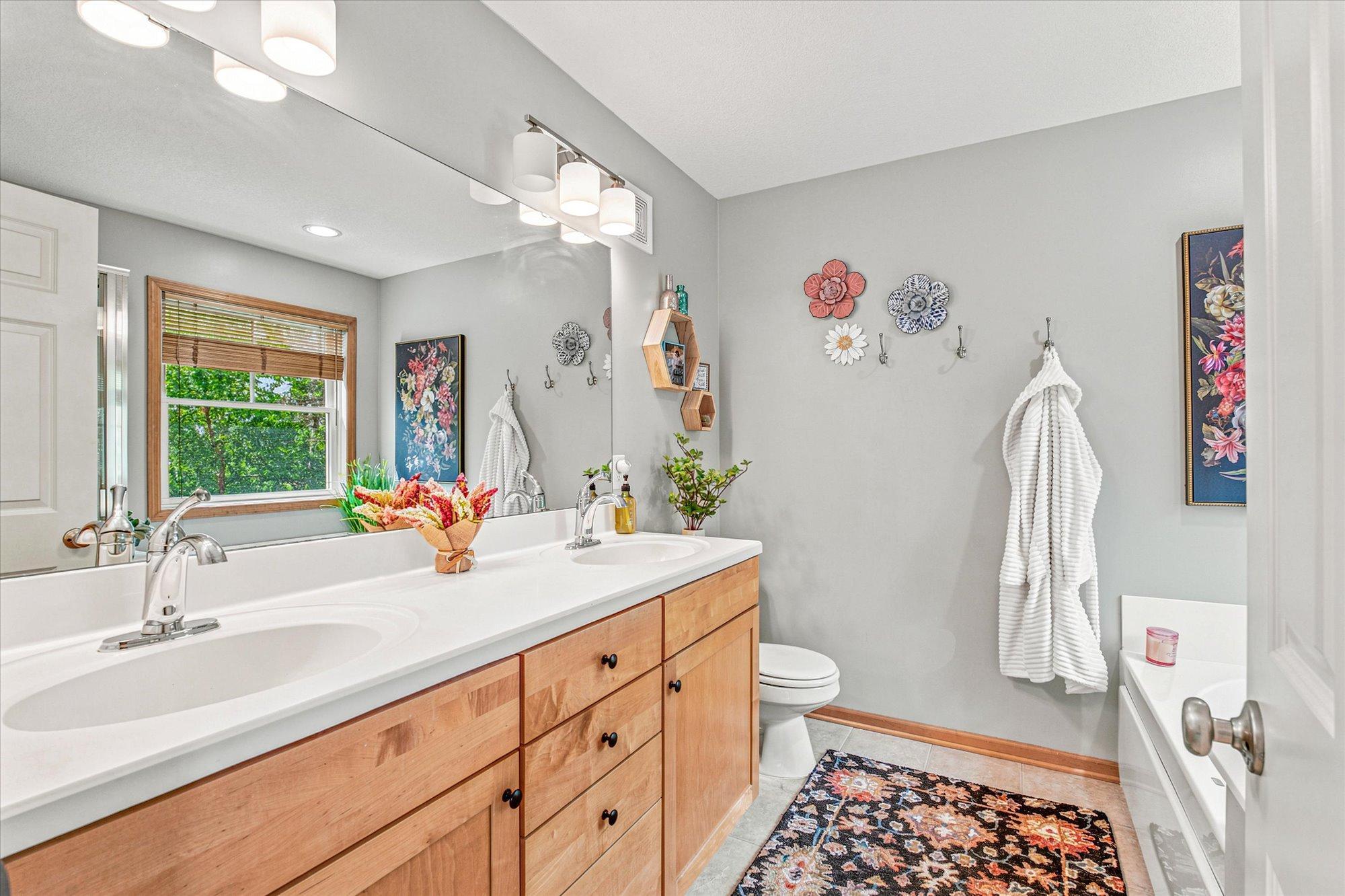 The private primary bath boasts double sinks, a soaking tub and a separate walk-in shower.