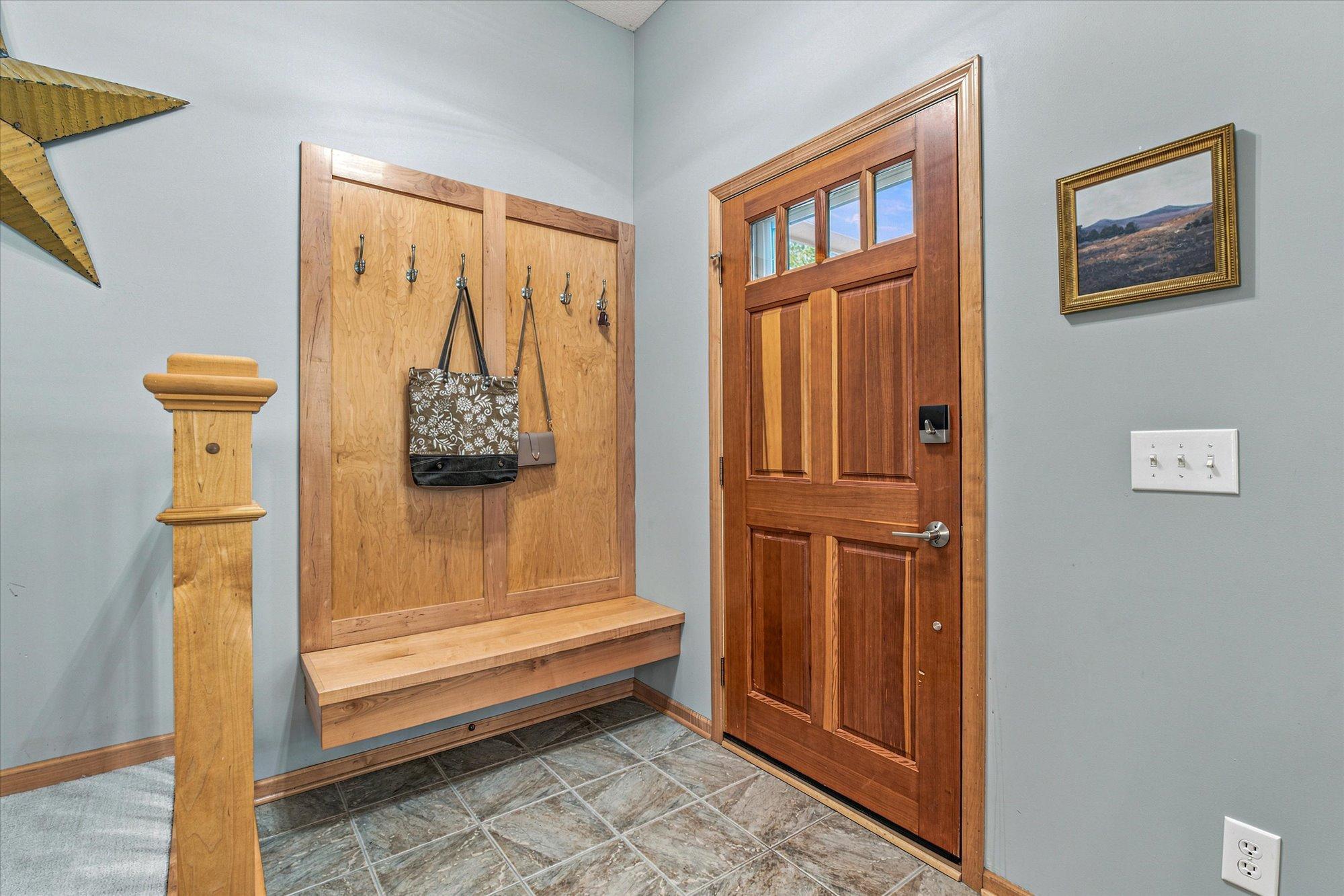 Upon entering through the front door, you and your guests can conveniently hang their coats and sit to take off your shoes.