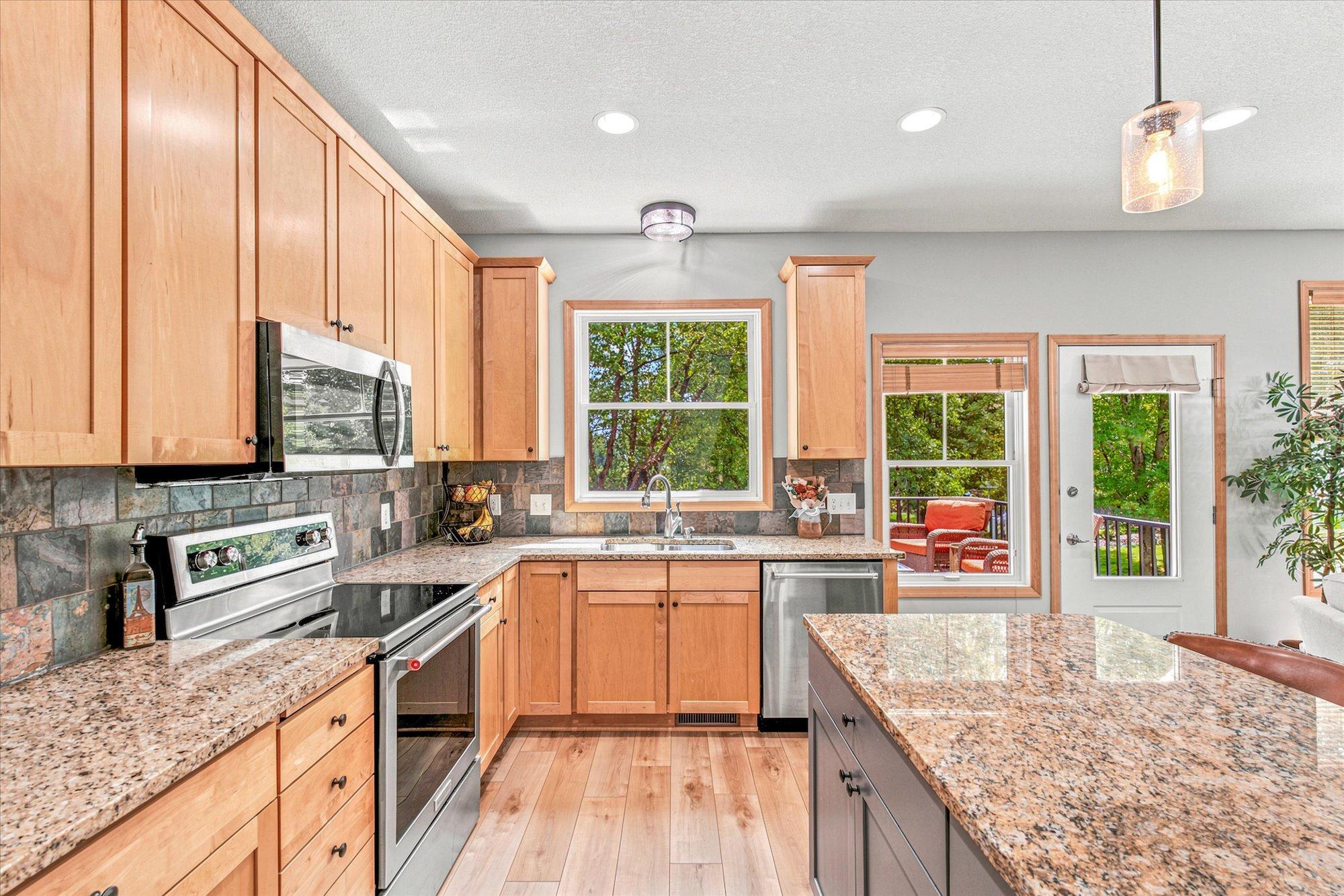 Granite countertops and maple cabinetry provide a timeless appeal.