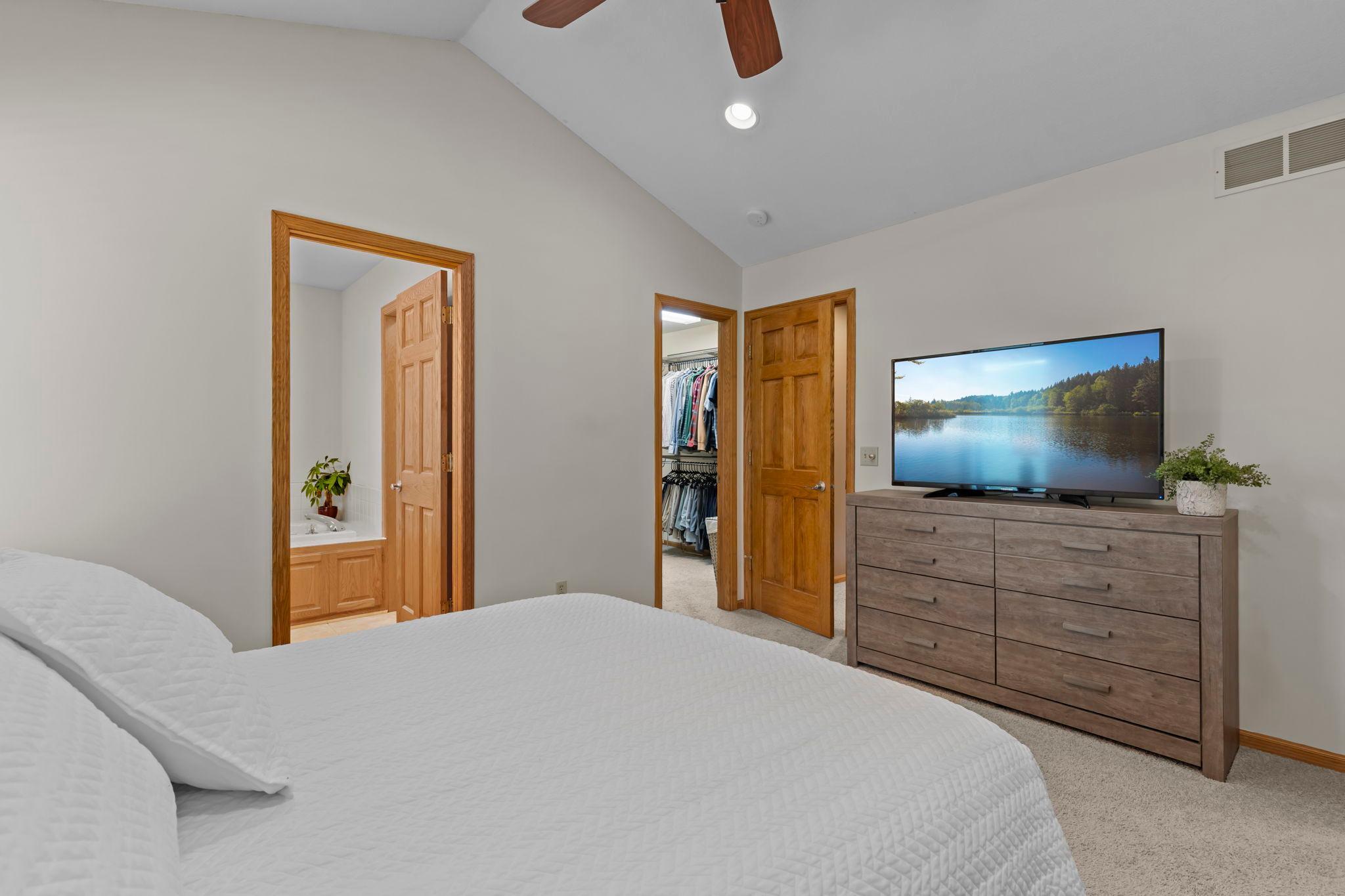 The primary suite is highlighted by vaulted ceilings and spacious walk-in closet with built-in organization.