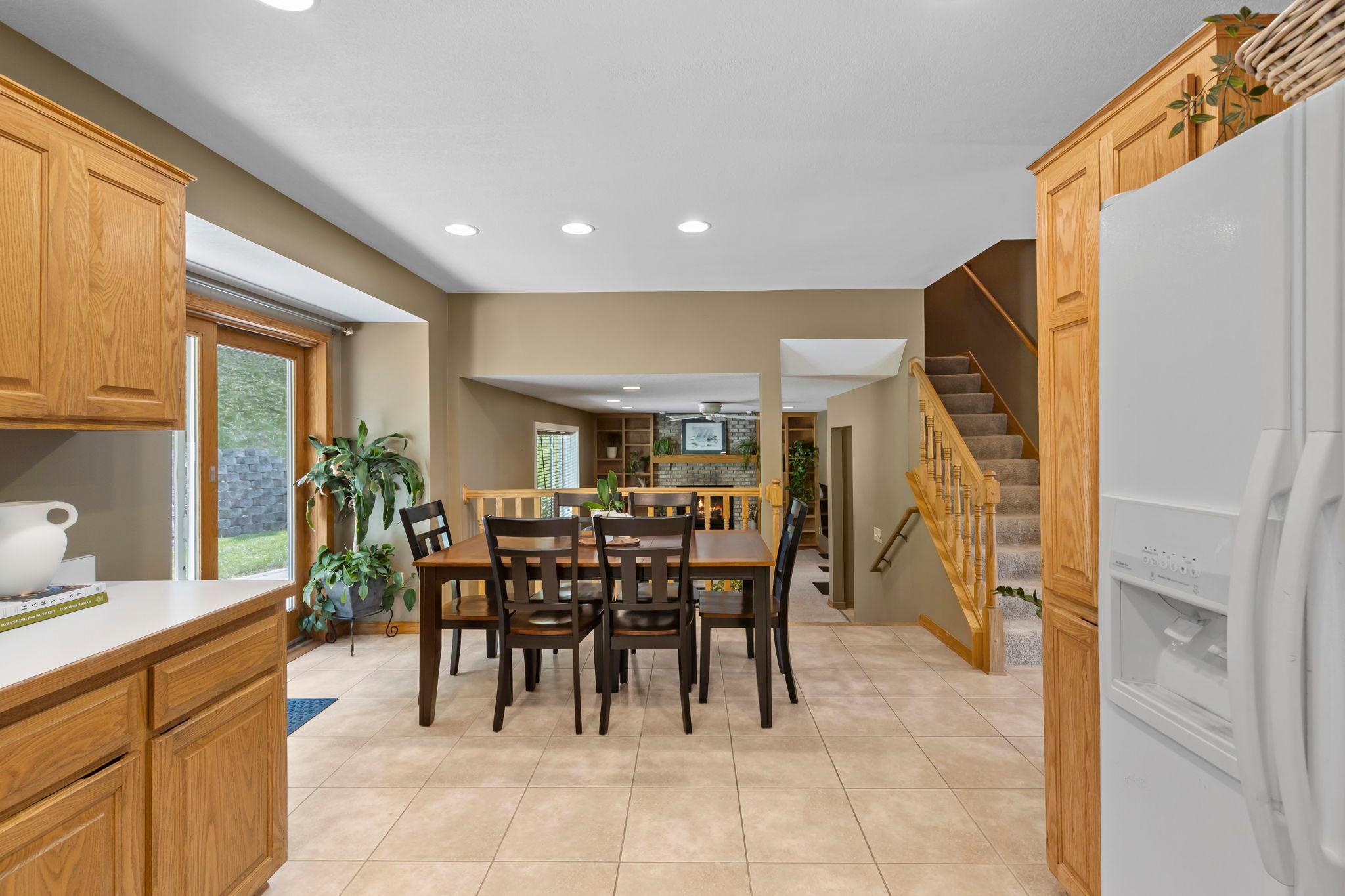 It opens naturally to the dining area, where sliding doors lead directly outside, making summer dinners and backyard get-togethers effortless.