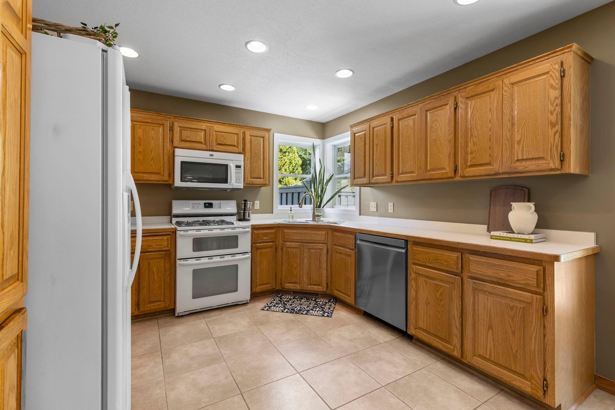 Abundant cabinet space, a pantry cabinet, double ovens, and a new dishwasher (2024).