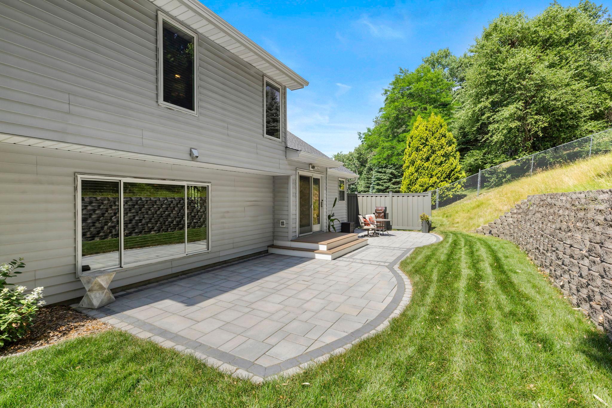 Step outside and you'll appreciate the privacy that's hard to find. Instead of looking directly into neighboring homes, the backyard backs to a hillside, creating a more peaceful setting surrounded by mature trees and landscaping.