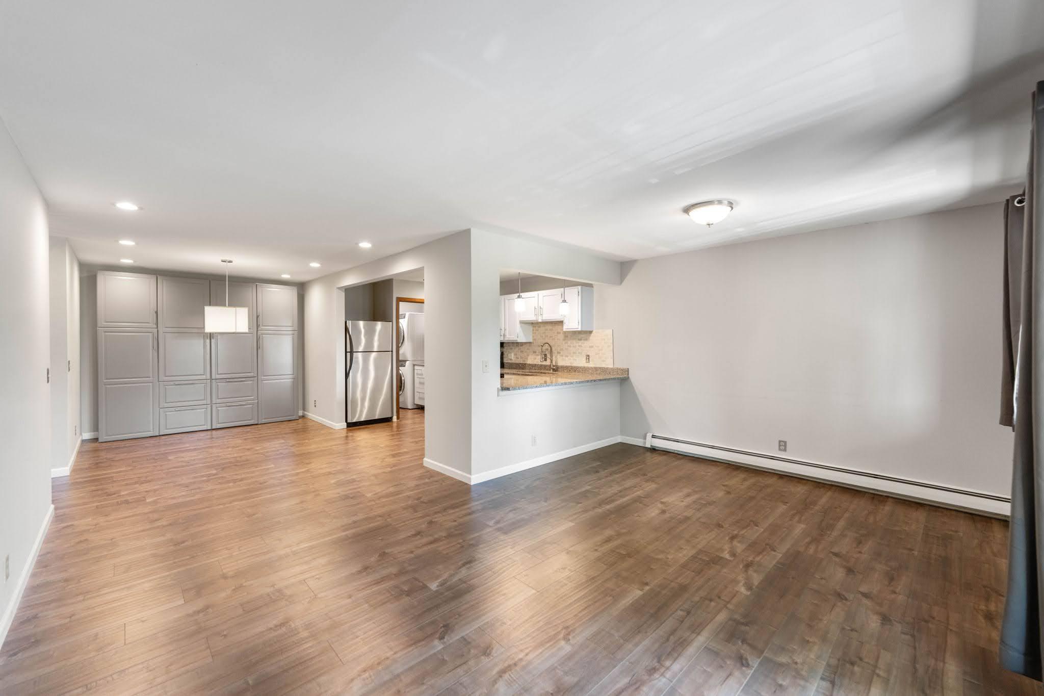 Living area looking into dining and kitchen
