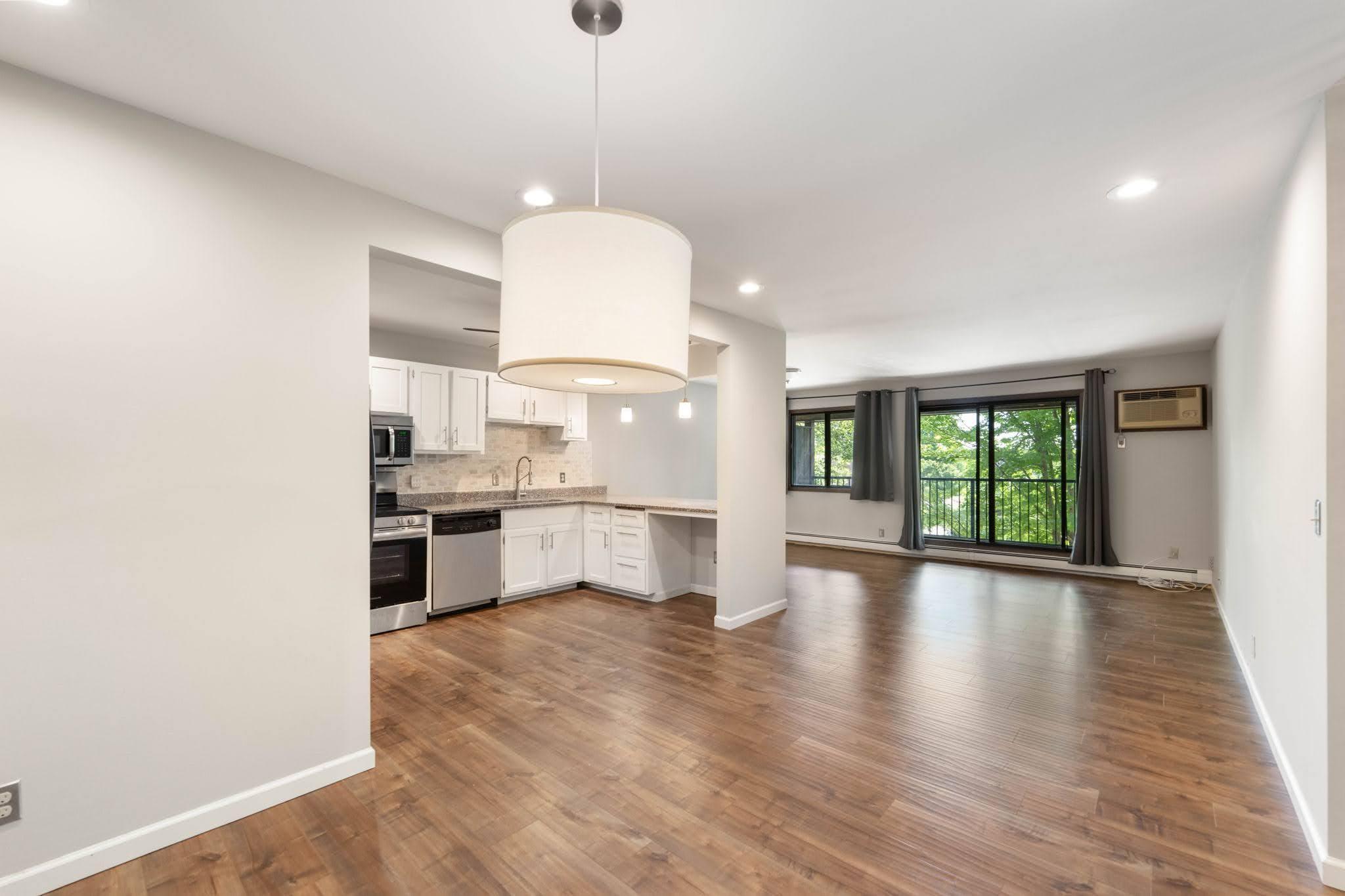 Open concept kitchen/living/dining with view to outside deck