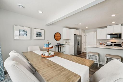 Thoughtfully designed kitchen with stainless appliance package including gas range, dishwasher and vented micro-hood. Photo of model home, color & options will vary.