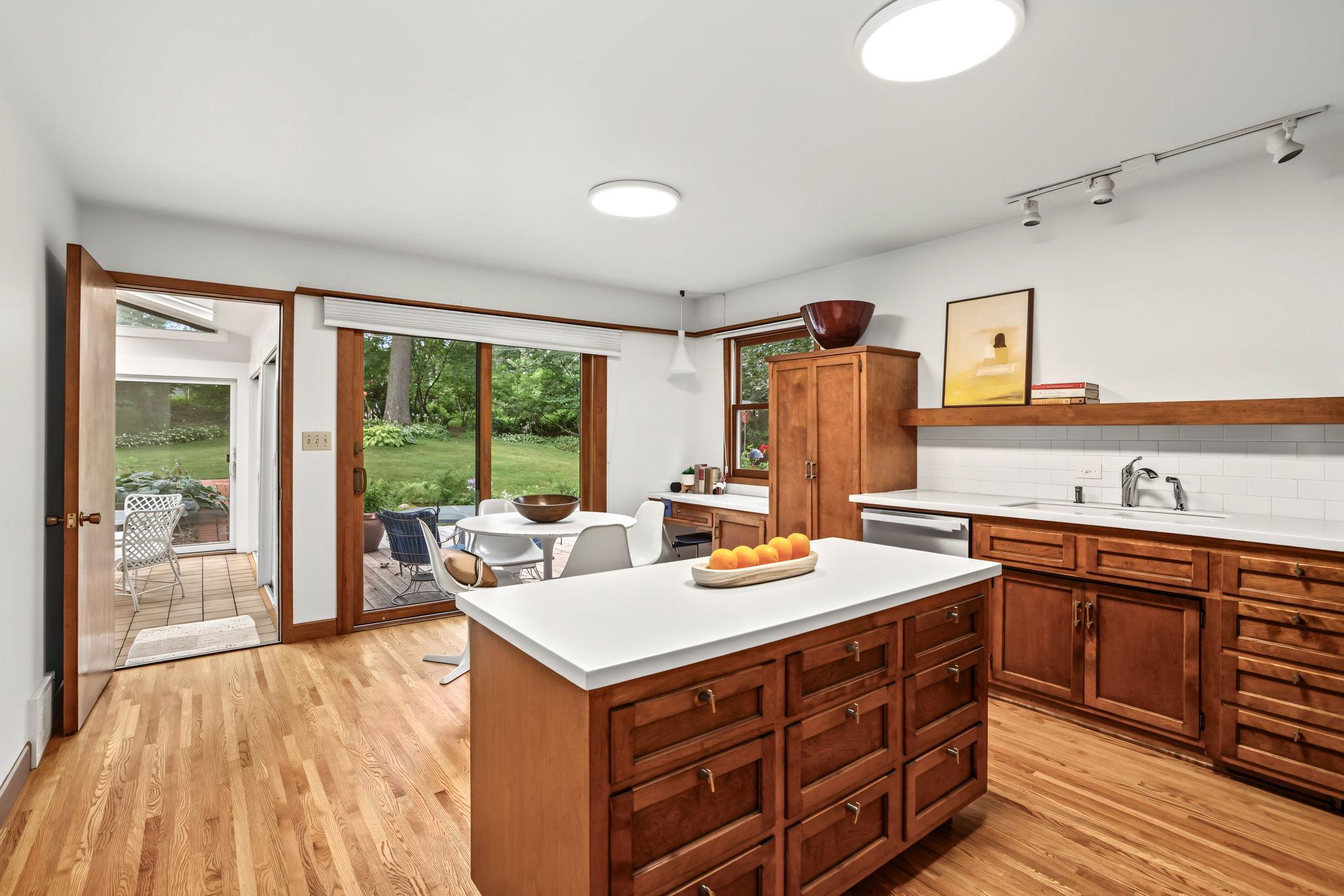 Spacious kitchen with center island and original custom cabinets.