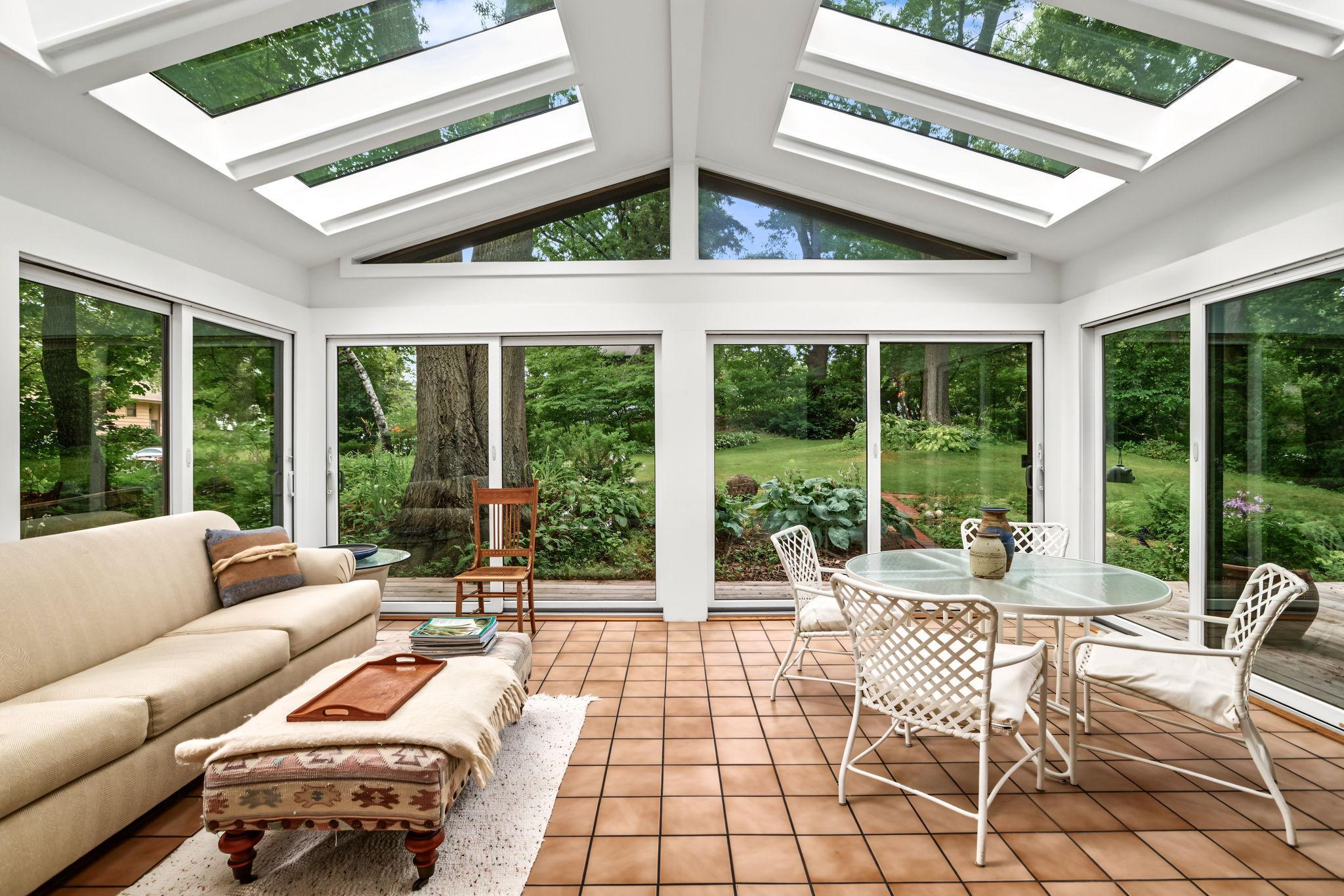 The sunroom has so many windows it feels like you're outside.