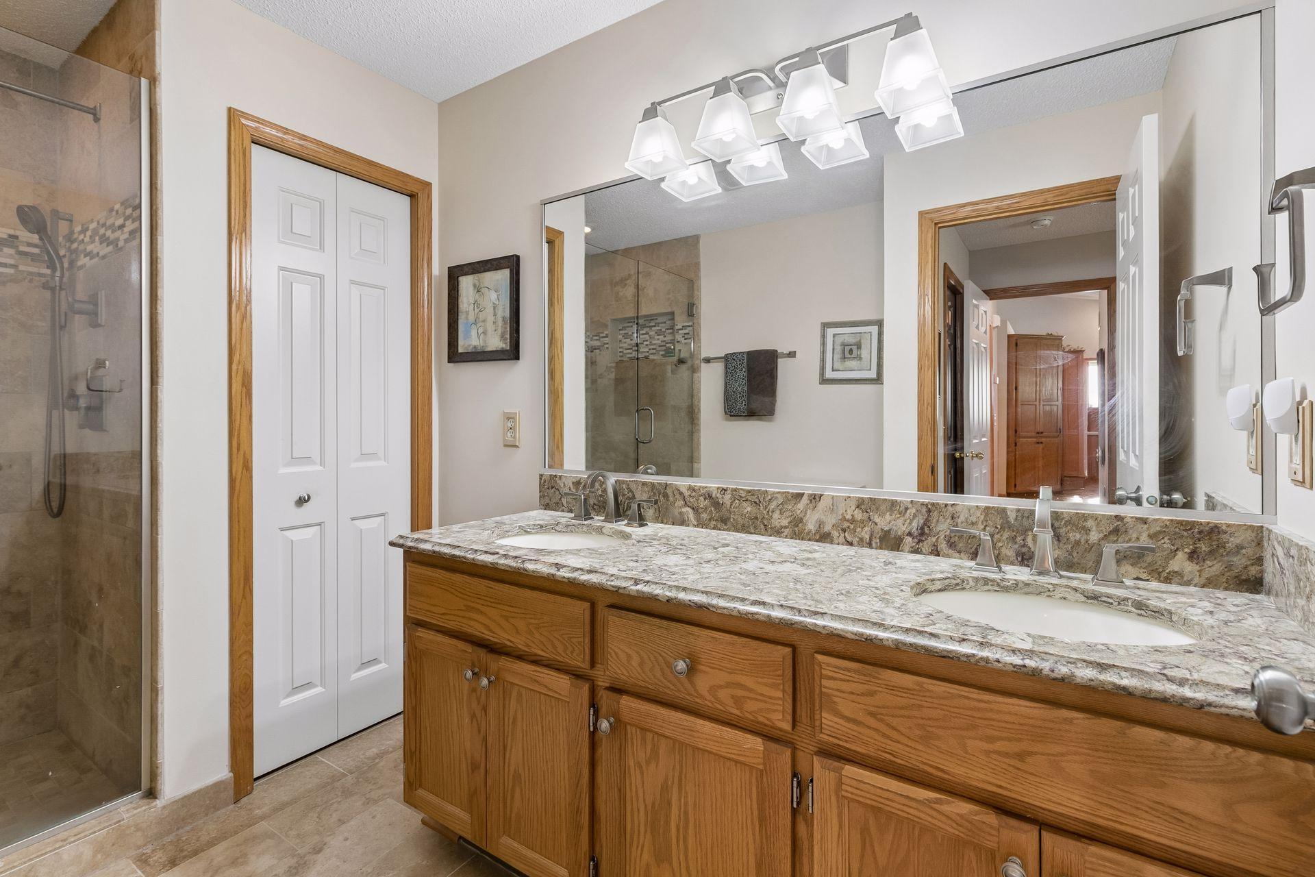 Primary bath with walk-in tile shower and double vanity