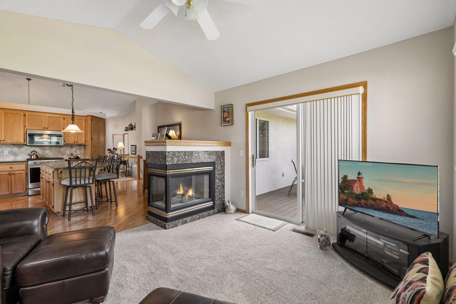 3-sided gas fireplace separates main level family room and kitchen