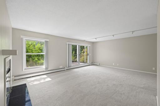 Unstaged Living room showing windows and Patio Door