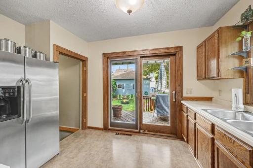 Solid wood slider to with interior blind element provides access to the back yard oasis!