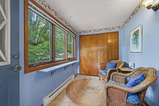 Welcoming sunroom with large coat closet.