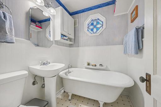 A great place for a bath! Enjoy the vintage clawfoot tub, pedestal sink, and elegant window allowing light with privacy.