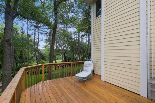 Newly refinished deck overlooking lush an beautiful yard.