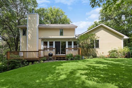 Newly refinished deck steps out to private backyard.