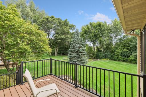 Sit and relax on the maintenance free deck overlooking the private backyard