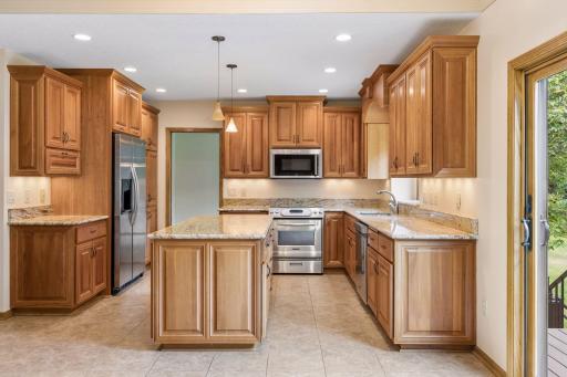 The chef's kitchen boasts cherry cabinets and granite countertops