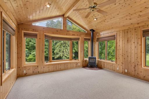 This cozy space has a fireplace and an abundance of windows