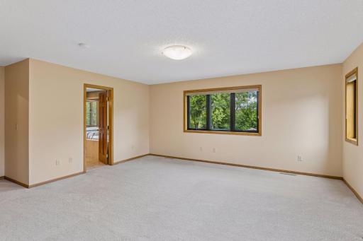 The primary bedroom looks out over the private backyard