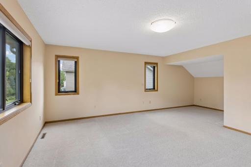 The large primary bedroom offers a cozy reading nook