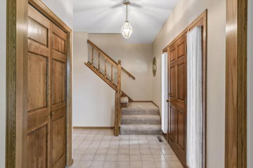 Step into the foyer with tile flooring and front hall closet